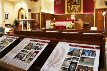 SINGLE USE - Posters describing Eucharistic miracles are displayed in pews at St. Edmund’s Church.